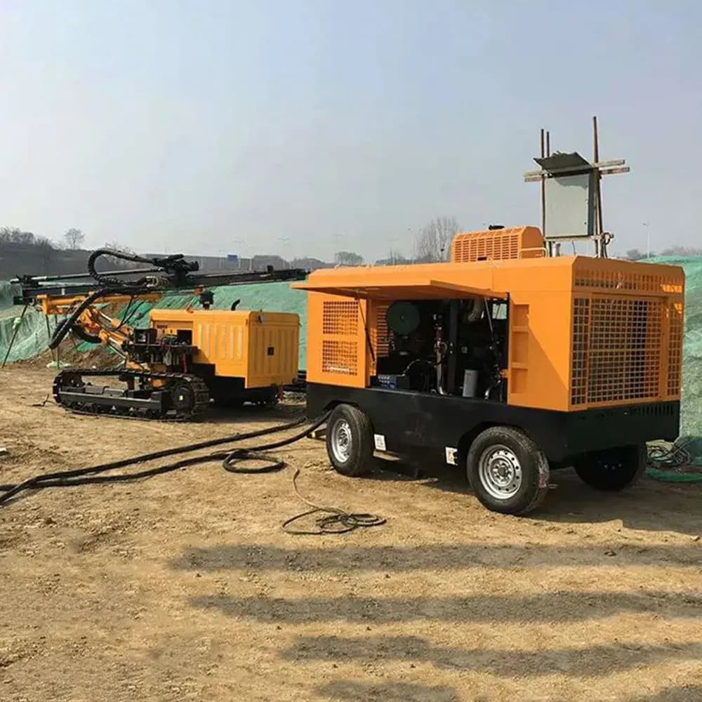 Mobile air compressor paired with a crawler drilling rig at a quarry site